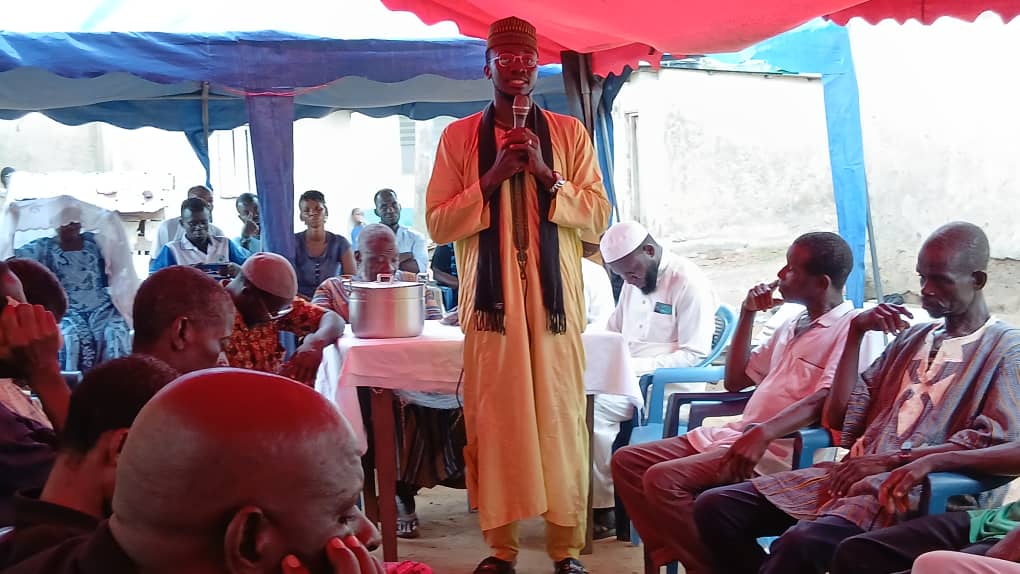 Sheikh Ishaque Abdallah preaching to a gathering of villagers